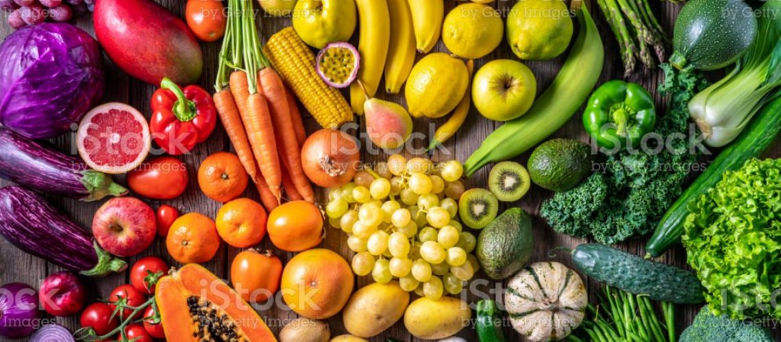 Colorful vegetables and fruits vegan food in rainbow colors arrangement full frame